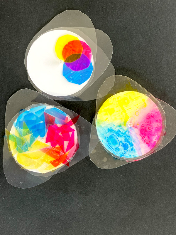 Three colourful abstract circular art pieces on black background