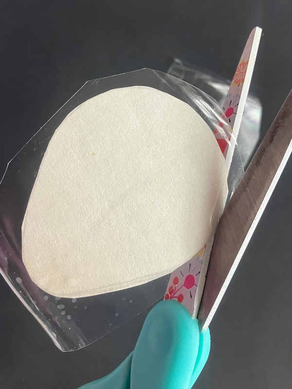 Cutting a makeup sponge with scissors