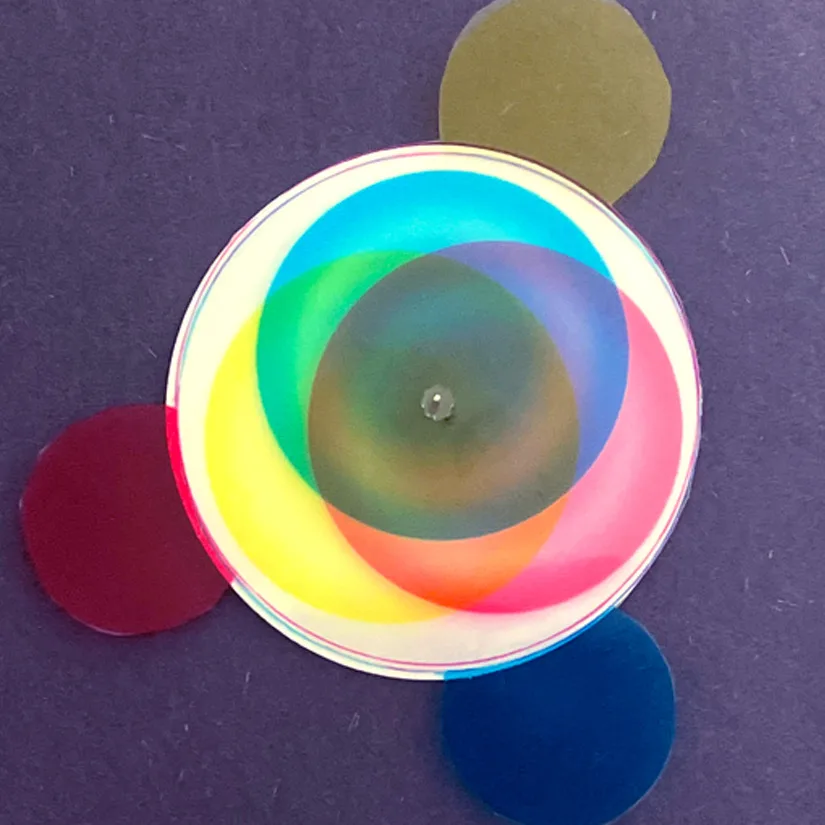 Colourful overlapping light circles on dark background