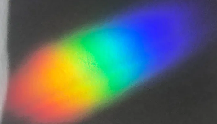 Blurred rainbow light spectrum on dark background